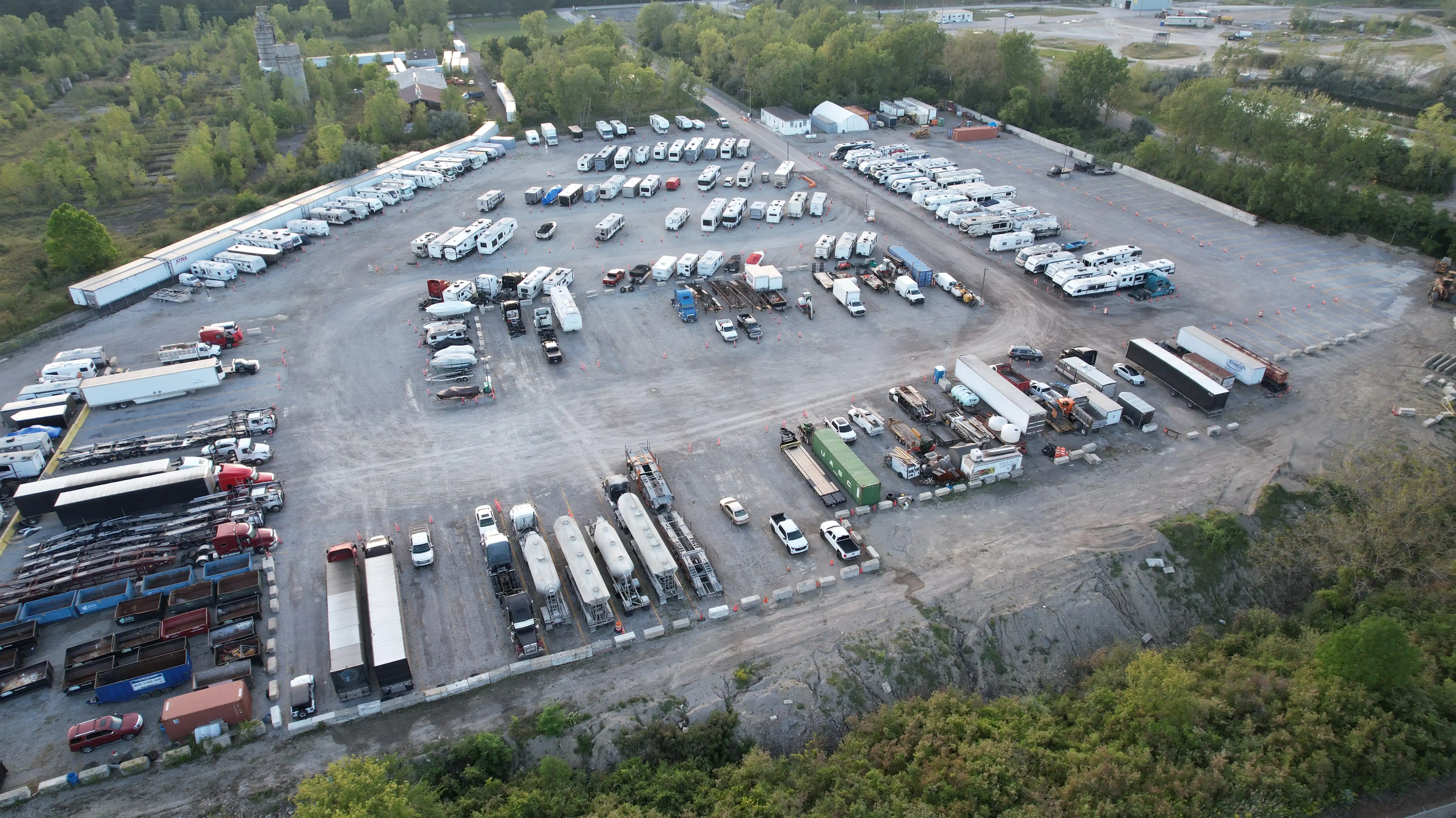 Aerial view of stored RVs and travel trailers lined up in marked spaces at Star Storage