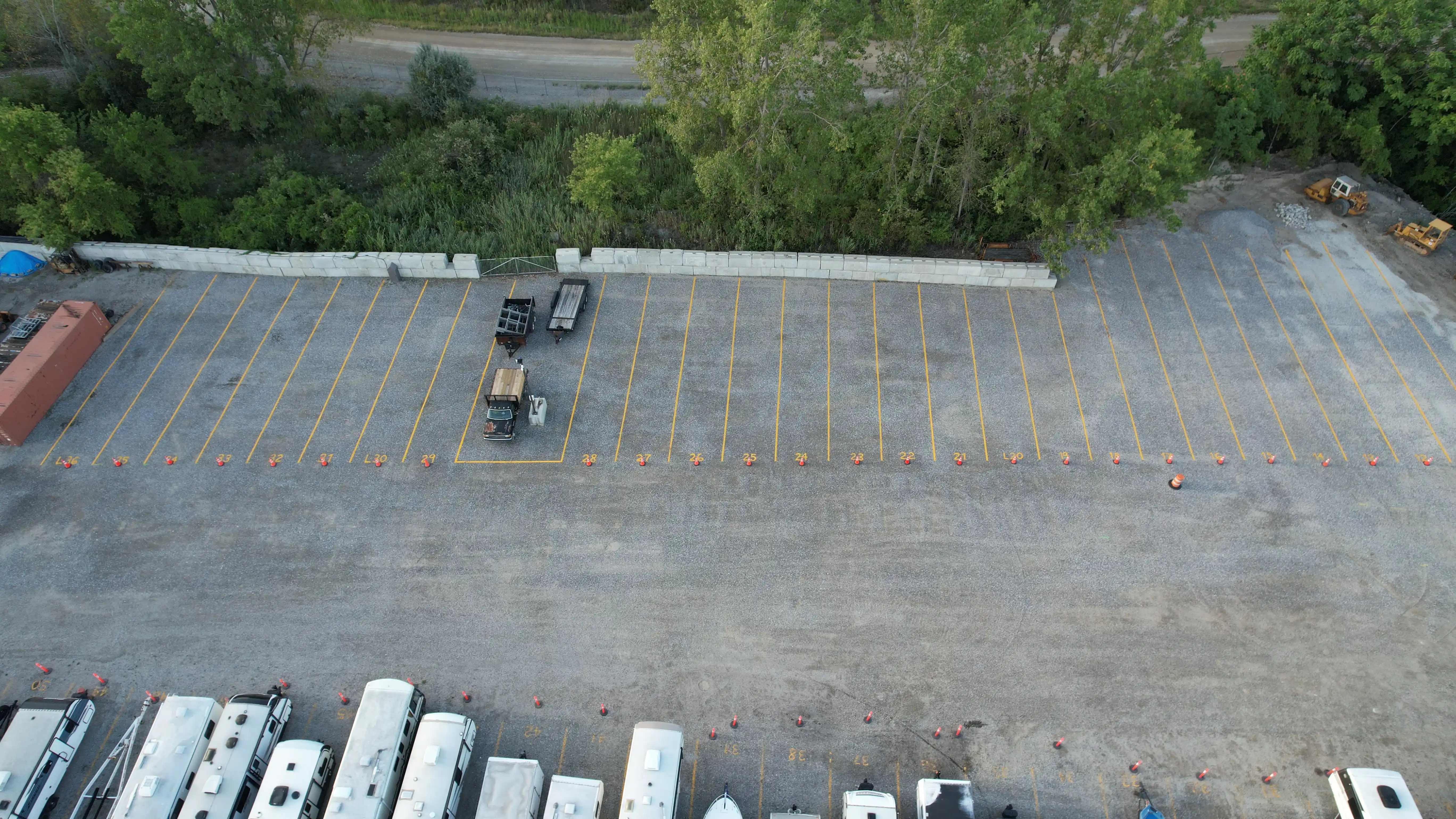 Overhead view of the storage yard showing wide drive aisles between rows of stored vehicles