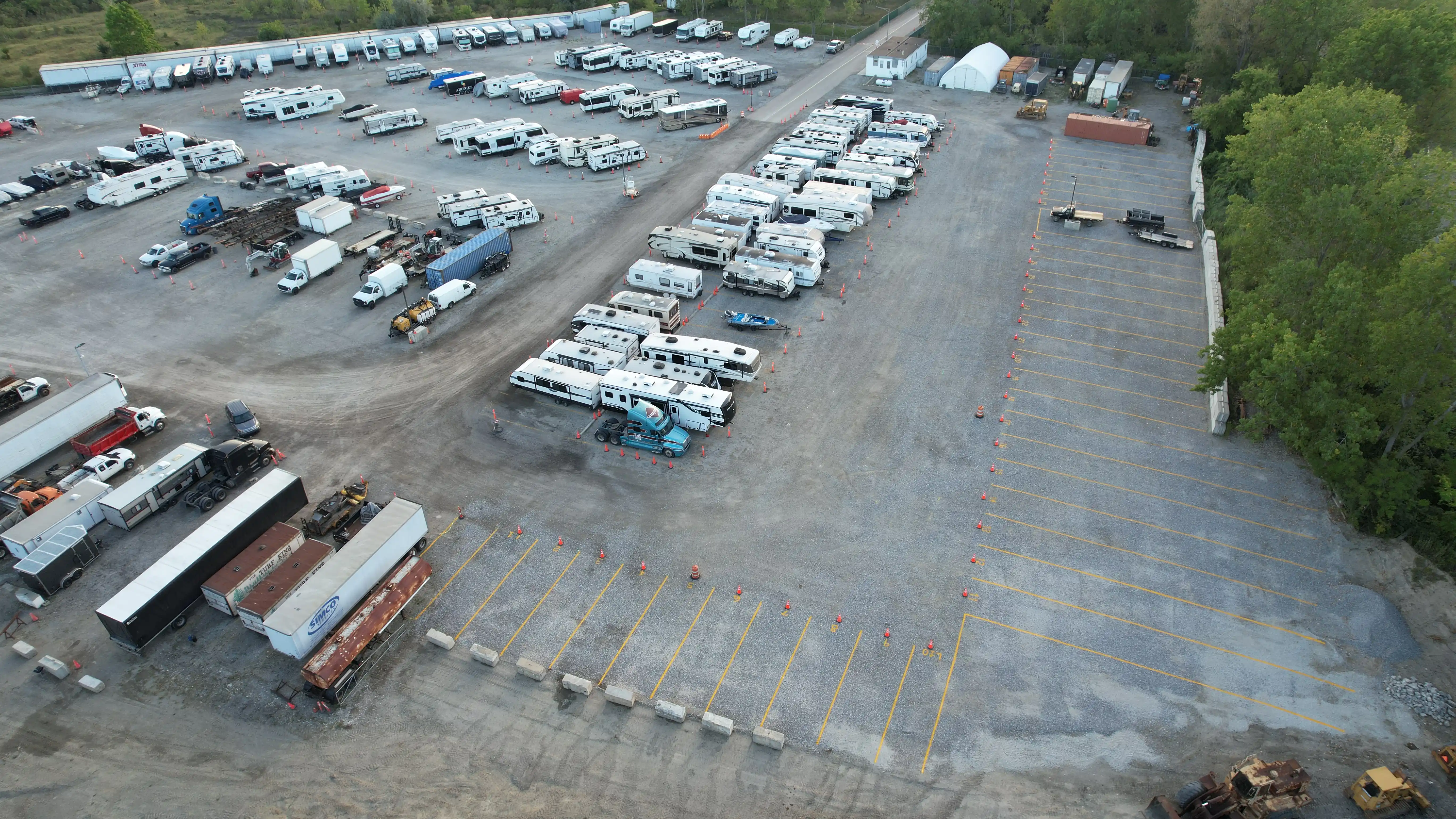 Aerial view of striped open spaces, stored RVs, semi trailers and the office area at Star Storage